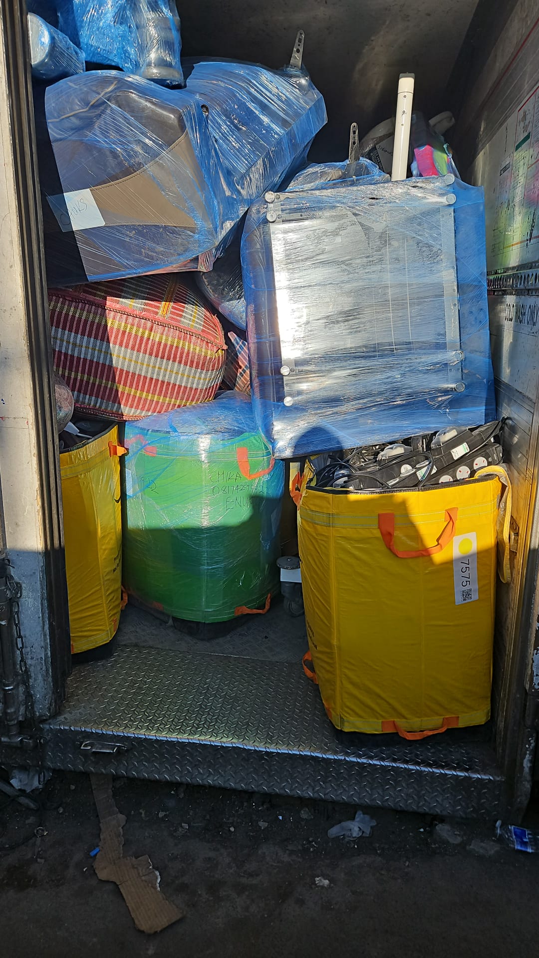 Furniture and bags loaded inside a cargo container